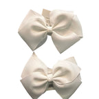 Adorable 1 pair of white and light pink ribbon bow hair clips with elegant white pearl accents, designed for little girls to wear.
