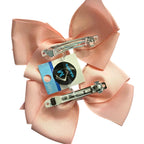 Adorable 1 pair of white and light pink ribbon bow hair clips with elegant white pearl accents, designed for little girls to wear.